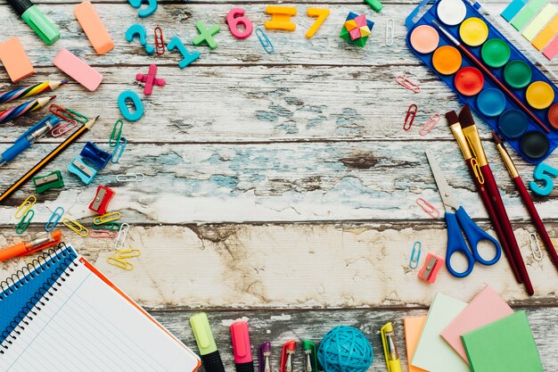 School supplies on rustic wooden table.