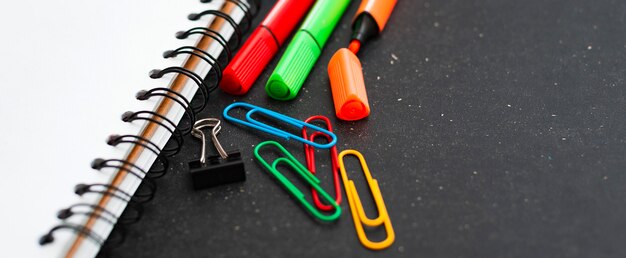 School supplies top view on the background of the chalkboard.