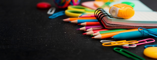 School supplies top view on the chalkboard.