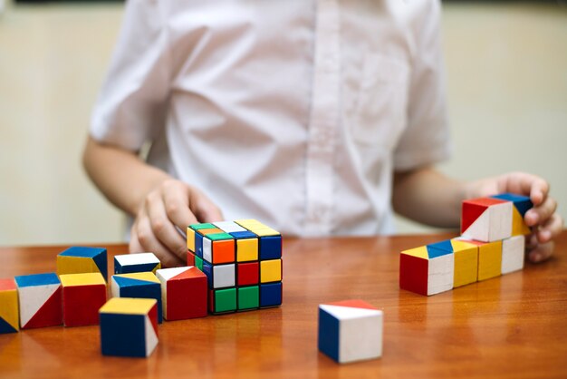 Schoolboy at desk with puzzles