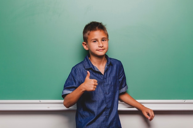 Schoolboy gesturing thumb up