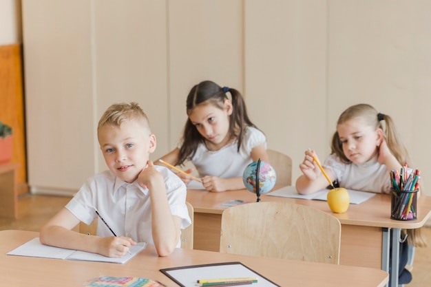 Schoolboy looking at camera at classroom