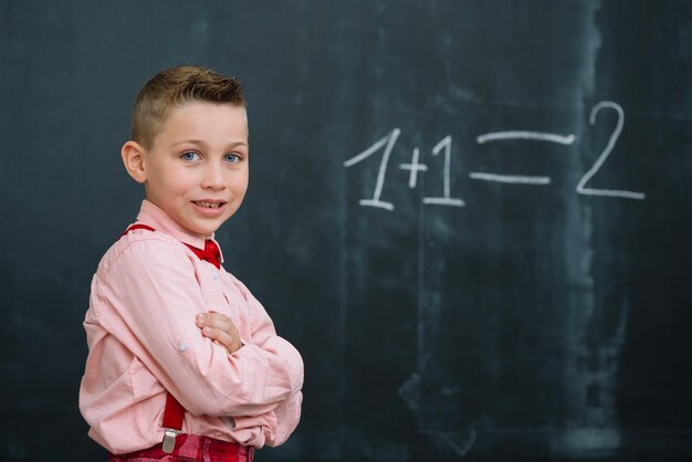 Schoolboy on math lesson with arms crossed