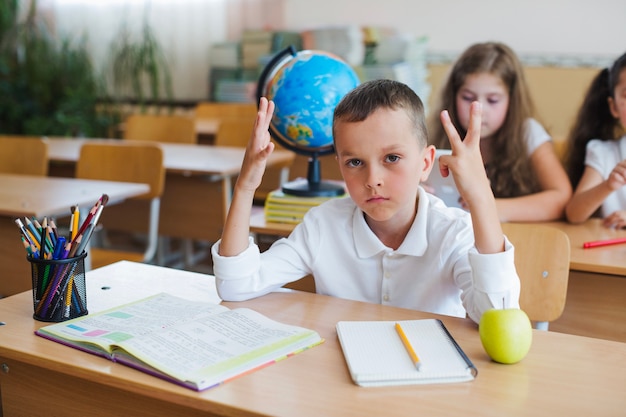 Schoolboy posing at desk