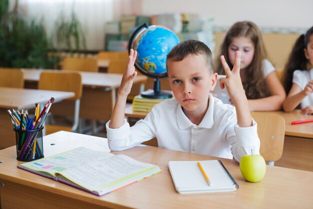 Schoolboy posing at desk