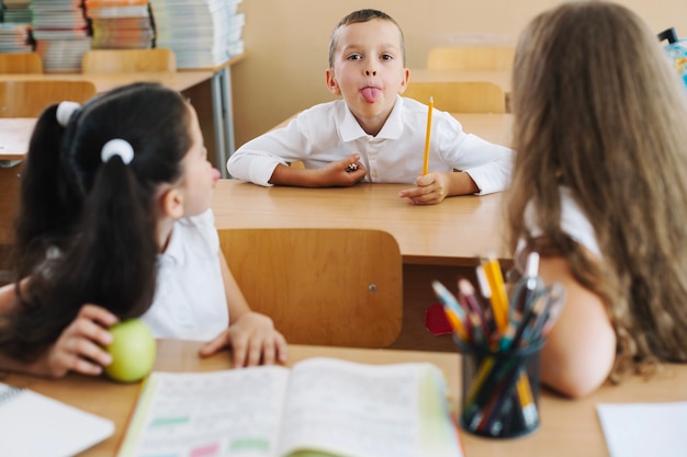 Free photo schoolboy showing tongue out