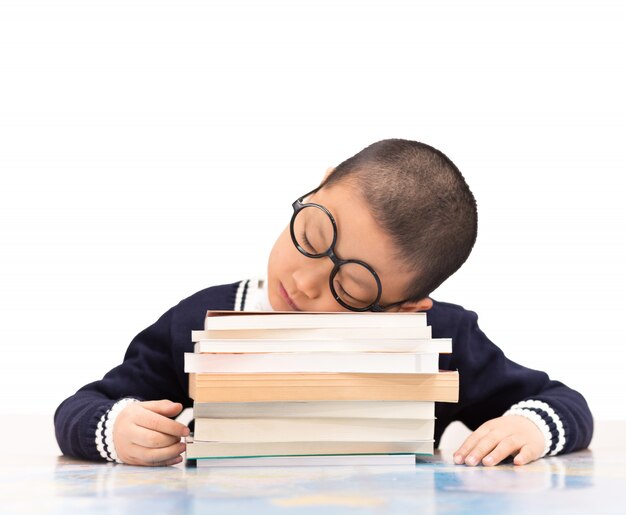 Schoolboy sleeping on school books