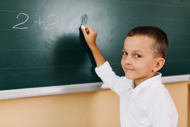 Schoolboy smiling in class