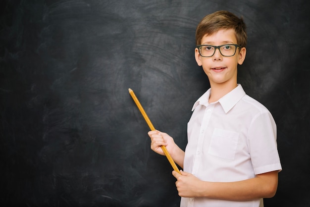 Schoolboy standing with pointer