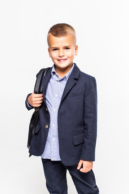 Schoolboy with bag isolated on a white wall