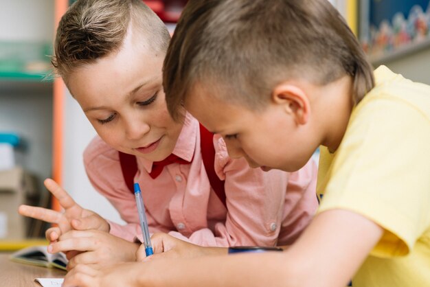 Schoolboys sitting at desk