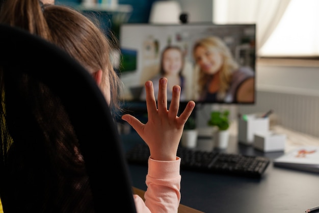 Schoolchild greeting remote friends discussing school leeson