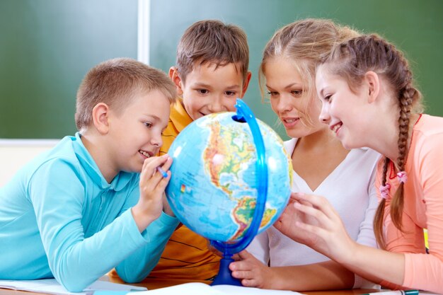 Schoolchildren learning with globe