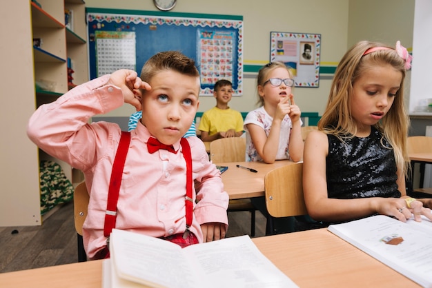 Schoolchildren sitting in classroom studying