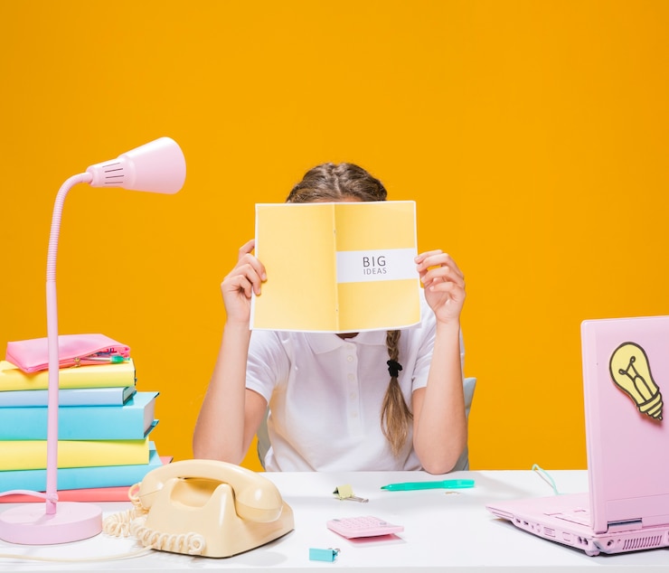 Free Photo schoolgirl on desk with laptop in memphis style