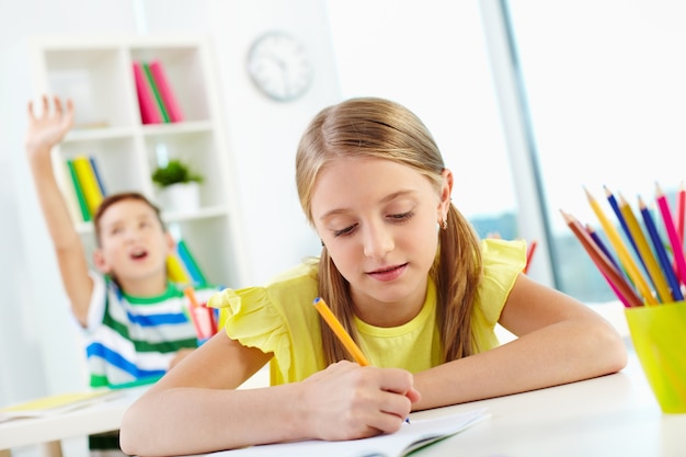 Free photo schoolgirl doing her homework