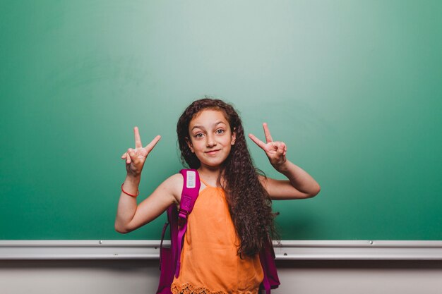 Schoolgirl gesturing two fingers