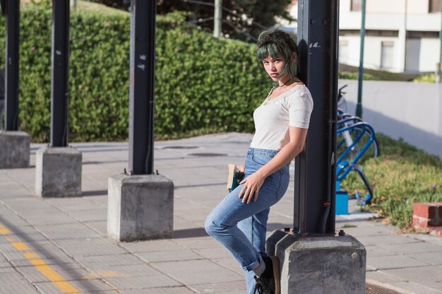 Schoolgirl leaning on pillar