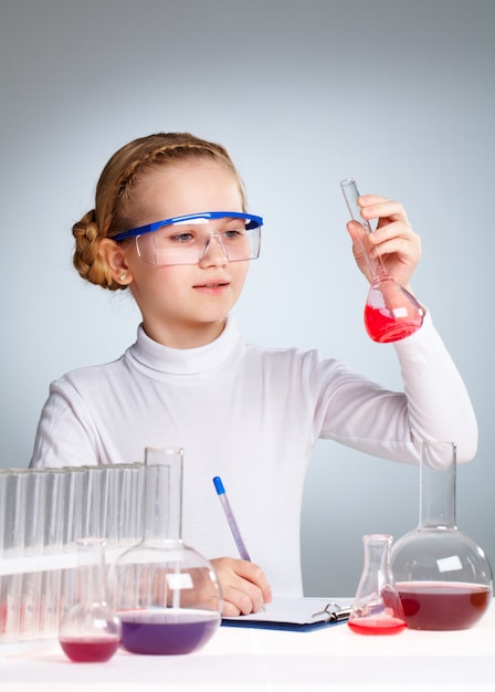 Schoolgirl looking at flask