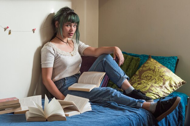 Schoolgirl sitting on bed