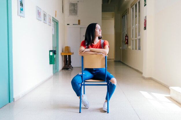 Schoolgirl sitting on chair