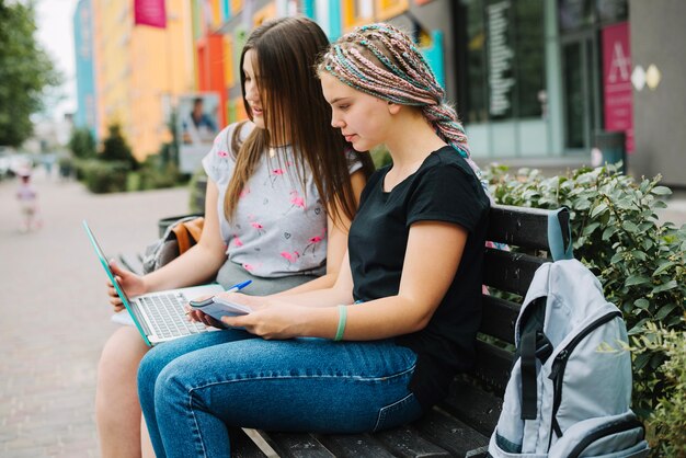 Schoolgirl studying on bench