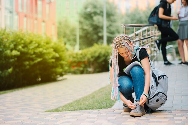 Schoolgirl tightening laces