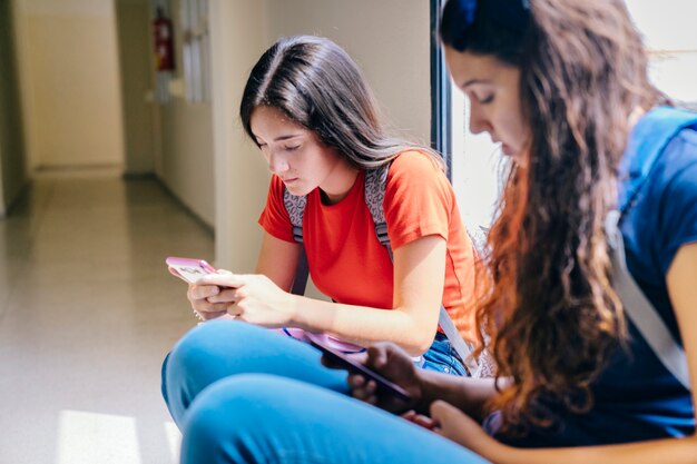 Schoolgirls with smartphone