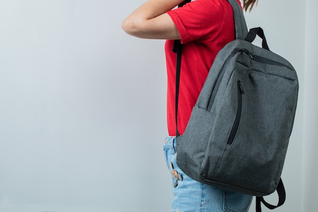 Schoolkid holding her backpack in the shoulders