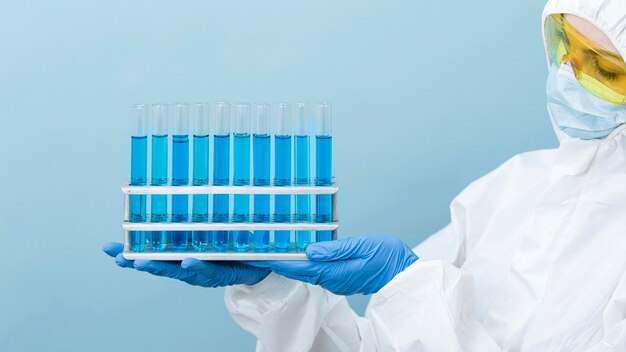 Scientist holding blue chemicals