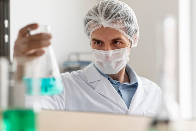 Scientist holding flask close up