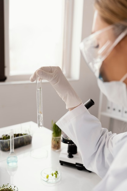 Free photo scientist holding tube with seed close up