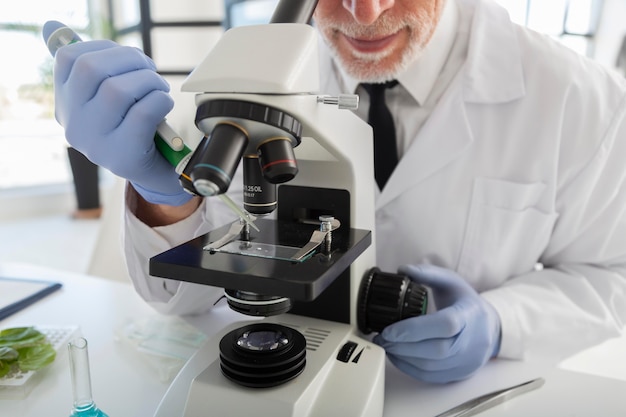 Scientist looking through microscope close up