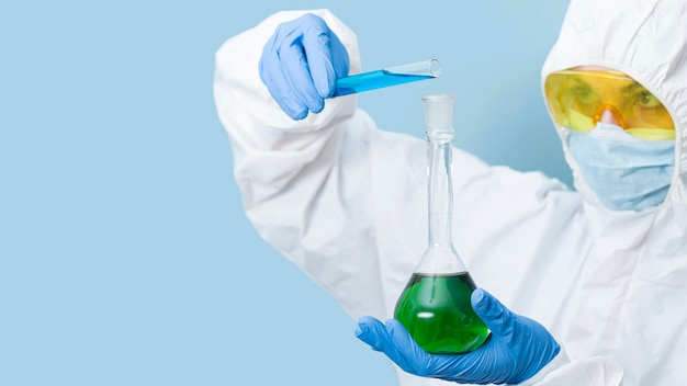 Scientist mixing chemicals with copy space