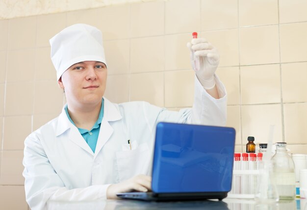 Free photo scientist with test tubes