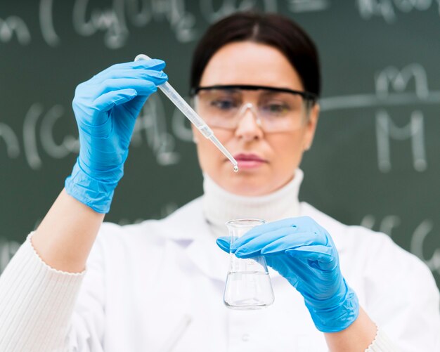 Scientist woman holding pipette