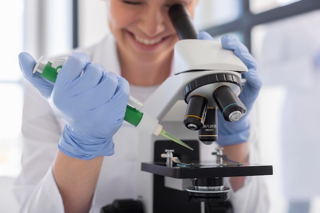 Scientist working with microscope close up