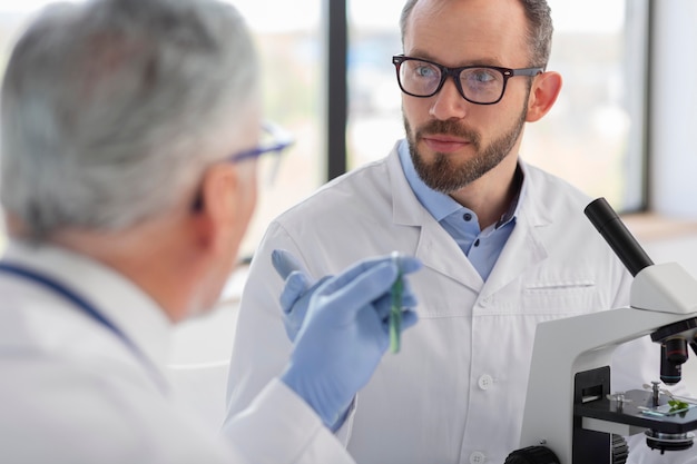 Scientist working with microscope close up