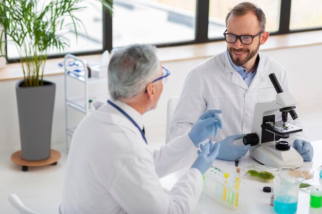 Scientist working with microscope medium shot