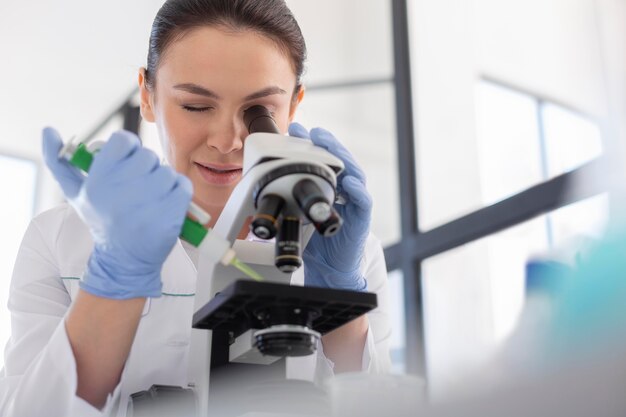 Scientist working with microscope