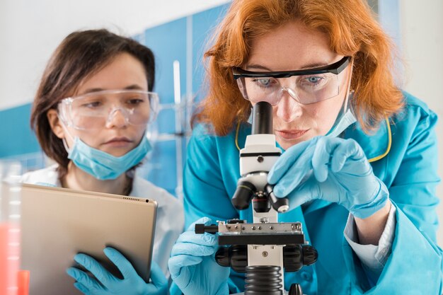 Scientists looking through a microscope