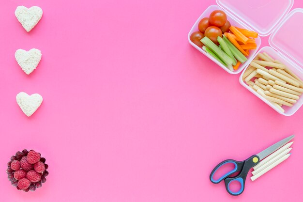 Scissors and pencils near healthy food