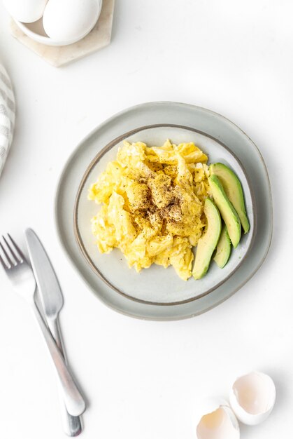 Scrambled eggs with avocado for breakfast