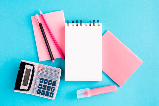 Scratchpad and office tools on blue surface