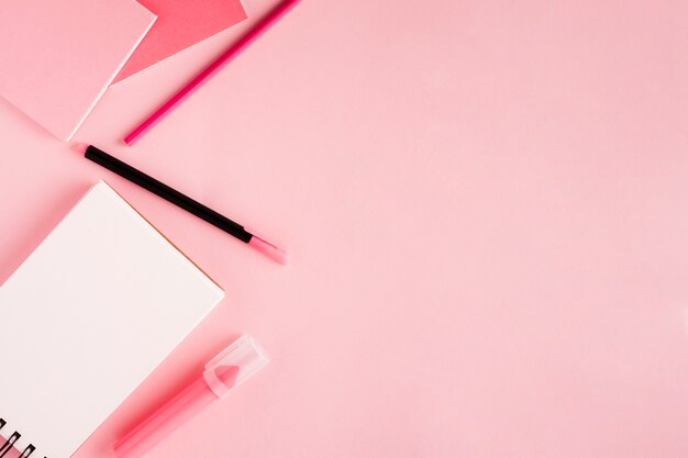 Scratchpad and stationery on colored background