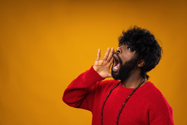 Screaming african american guy against yellow background