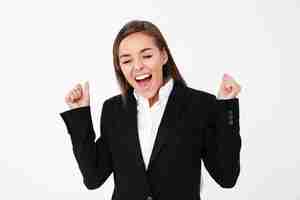 Free photo screaming excited business woman standing isolated