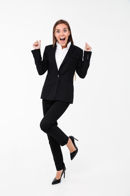 Screaming excited business woman standing isolated