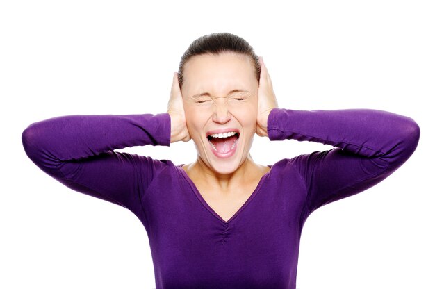 Free photo screaming female face squeeze her ears by hand