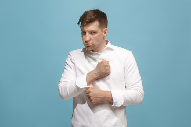 Screaming, hate, rage. Crying emotional angry man screaming on blue studio background. Emotional, young face. male half-length portrait. Human emotions, facial expression concept. Trendy colors